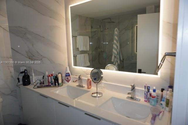 701 Brickell Key Boulevard, Unit 412 Miami, FL 33131 - Photo 20 of 37 a bathroom with a sink and a mirror