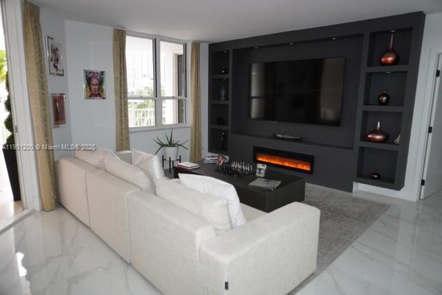 701 Brickell Key Boulevard, Unit 412 Miami, FL 33131 - Photo 2 of 37 a living room with furniture and a flat screen tv