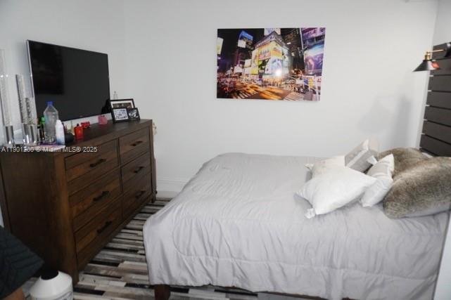 701 Brickell Key Boulevard, Unit 412 Miami, FL 33131 - Photo 28 of 37 a bedroom with a bed and a flat screen tv