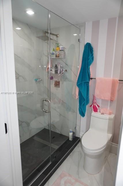 701 Brickell Key Boulevard, Unit 412 Miami, FL 33131 - Photo 5 of 37 a bathroom with a toilet and a shower