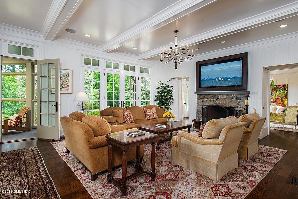 16 Doubling Road Greenwich, CT 06830 - Photo 12 of 45 a living room with furniture a fireplace and a large window