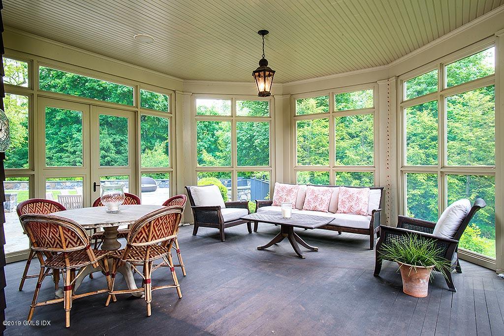 16 Doubling Road Greenwich, CT 06830 - Photo 13 of 45 a living room with furniture and floor to ceiling windows