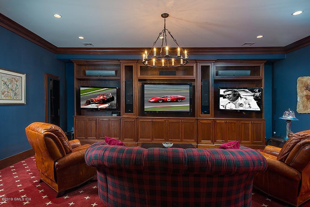 16 Doubling Road Greenwich, CT 06830 - Photo 21 of 45 a bedroom with a bed and a chandelier