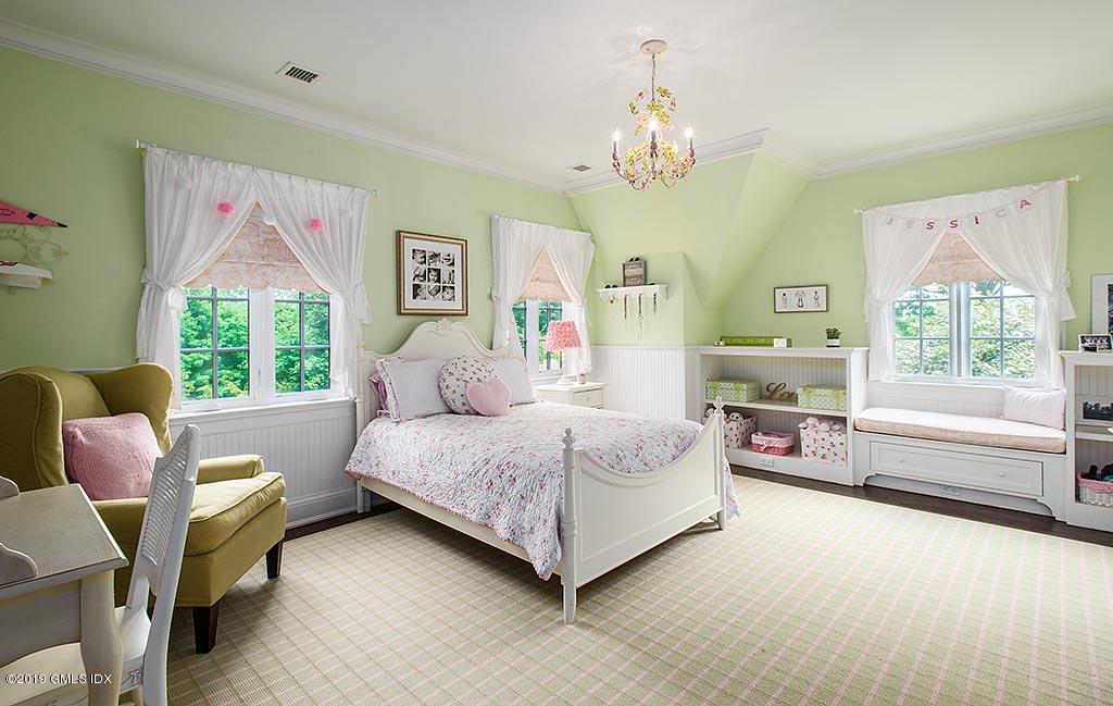 16 Doubling Road Greenwich, CT 06830 - Photo 31 of 45 a spacious bedroom with a bed and a large window