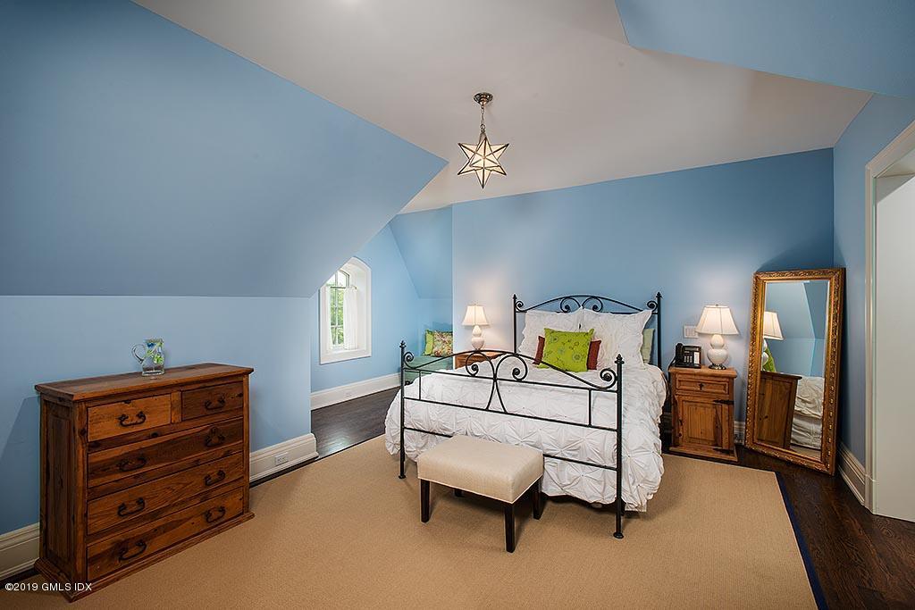 16 Doubling Road Greenwich, CT 06830 - Photo 35 of 45 a bedroom with furniture and a chandelier