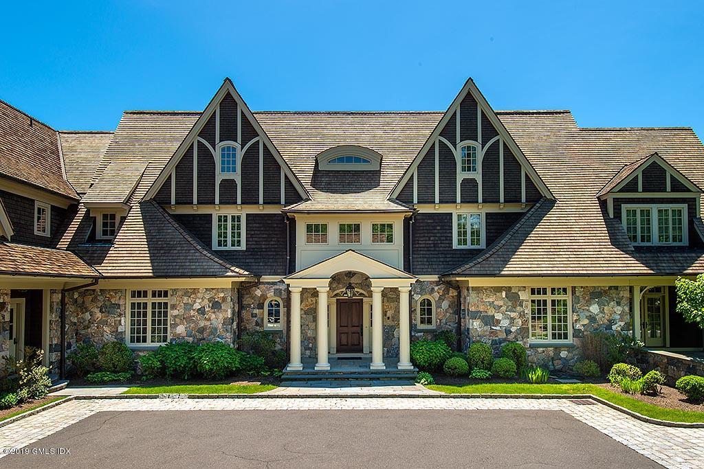 16 Doubling Road Greenwich, CT 06830 - Photo 8 of 45 a view of a white house with large windows and a road