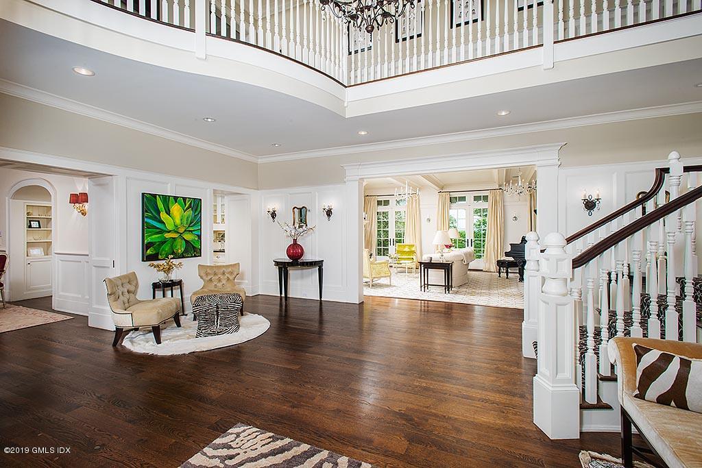 16 Doubling Road Greenwich, CT 06830 - Photo 9 of 45 a living room with couches and a dining table with wooden floor
