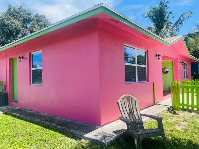 a patio with red chair table and chairs