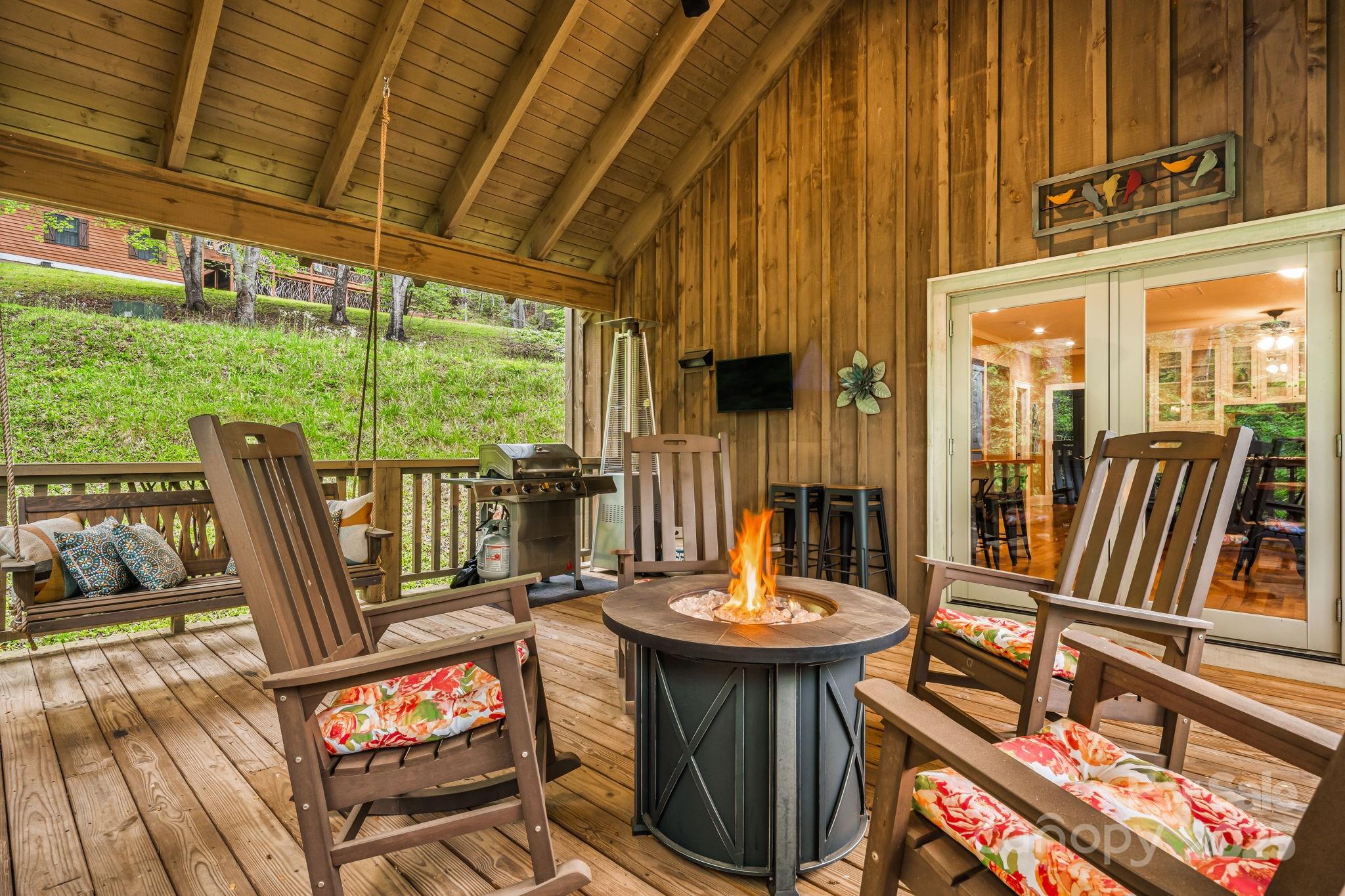 79 Slumber Lane Sylva, NC 28779 - Photo 19 of 29 a view of a patio with a table chairs and a small yard