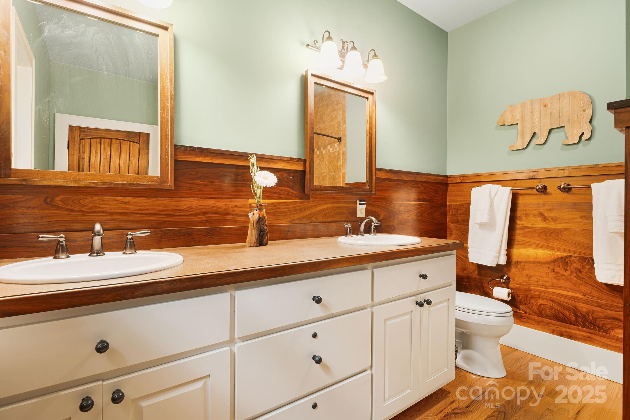 79 Slumber Lane Sylva, NC 28779 - Photo 27 of 29 a bathroom with a sink a toilet and a mirror