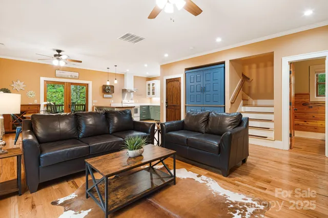 a living room with furniture and wooden floor