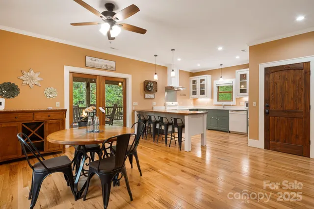 a dining area with stainless steel appliances kitchen island granite countertop a dining table chairs and granite counter tops