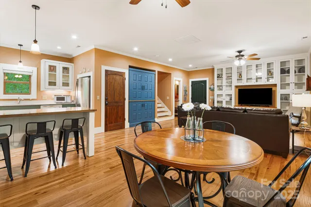 a dining room with furniture and wooden floor