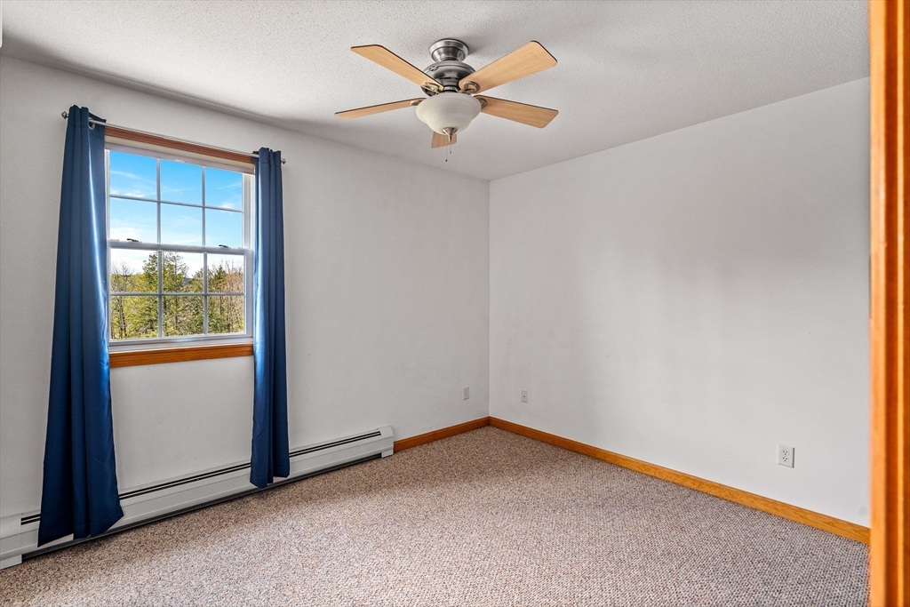 574 Main Road Chesterfield, MA 01012 - Photo 33 of 42 an empty room with a window and a ceiling fan