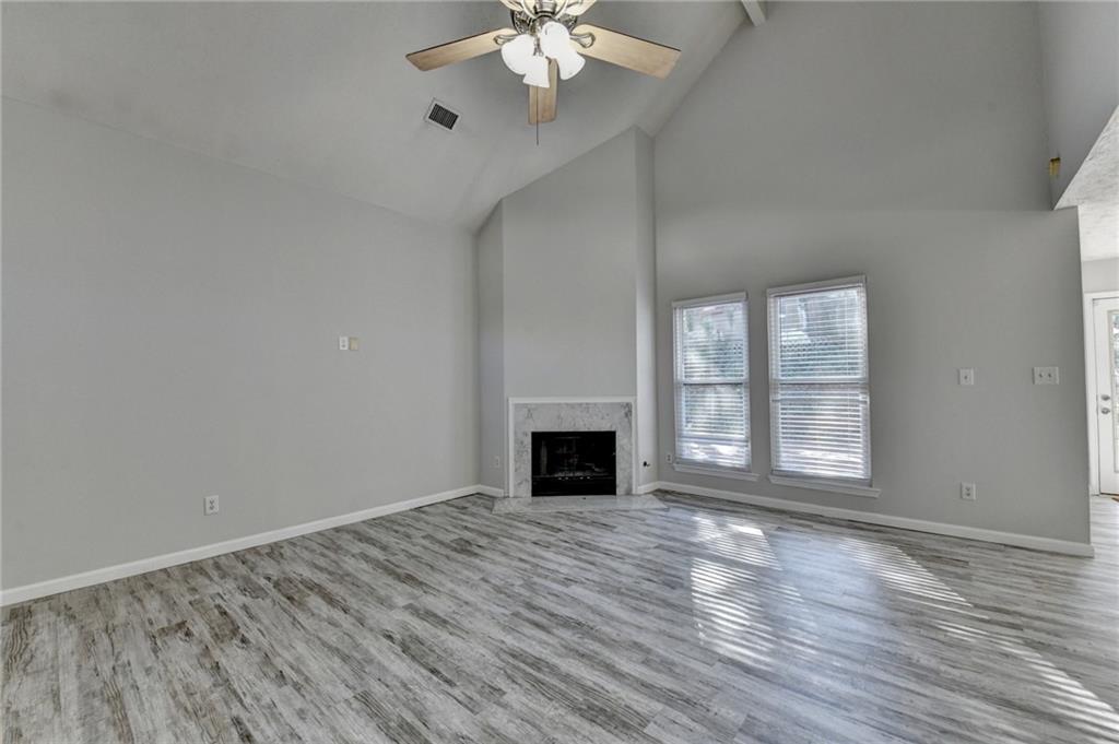 1112 Ashbury Drive Decatur, GA 30030 - Photo 11 of 64 a view of an empty room with window and wooden floor