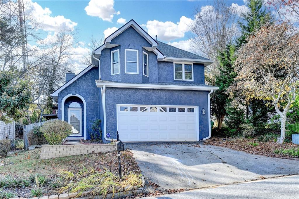 1112 Ashbury Drive Decatur, GA 30030 - Photo 3 of 64 a front view of a house with a yard and garage