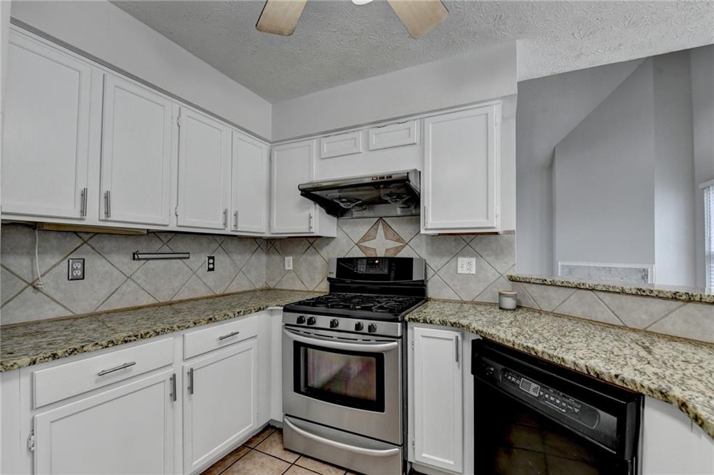 1112 Ashbury Drive Decatur, GA 30030 - Photo 31 of 64 a kitchen with granite countertop a stove sink and cabinets