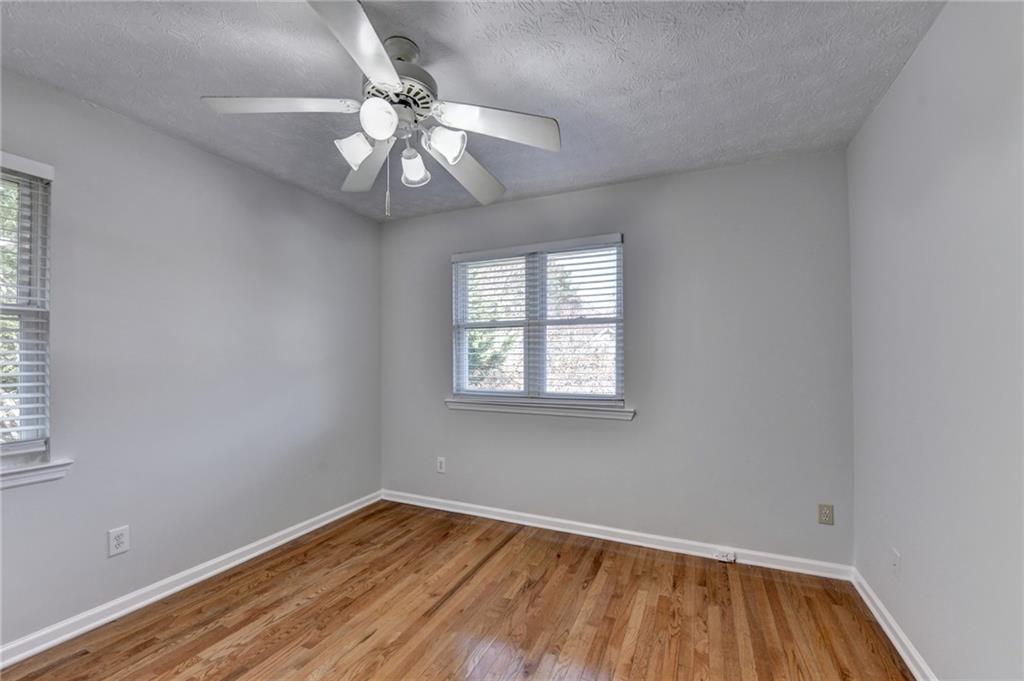 1112 Ashbury Drive Decatur, GA 30030 - Photo 41 of 64 an empty room with a window and wooden floor