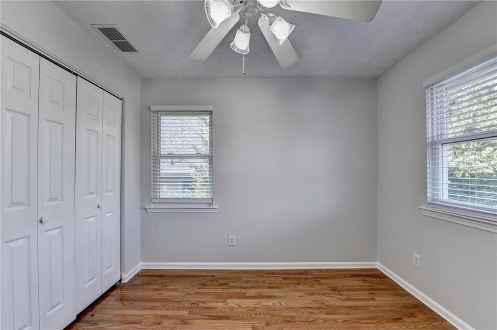 1112 Ashbury Drive Decatur, GA 30030 - Photo 42 of 64 a view of an empty room with wooden floor and a window