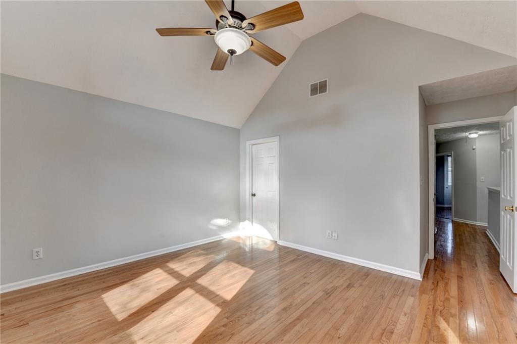 1112 Ashbury Drive Decatur, GA 30030 - Photo 47 of 64 an empty room with wooden floor fan and windows