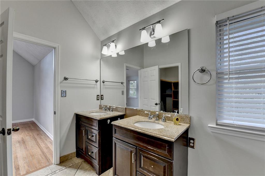 1112 Ashbury Drive Decatur, GA 30030 - Photo 54 of 64 a bathroom with a sink a mirror and a shower