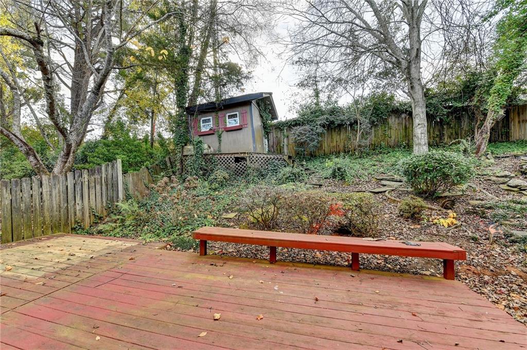 1112 Ashbury Drive Decatur, GA 30030 - Photo 58 of 64 a wooden bench sitting in middle of forest