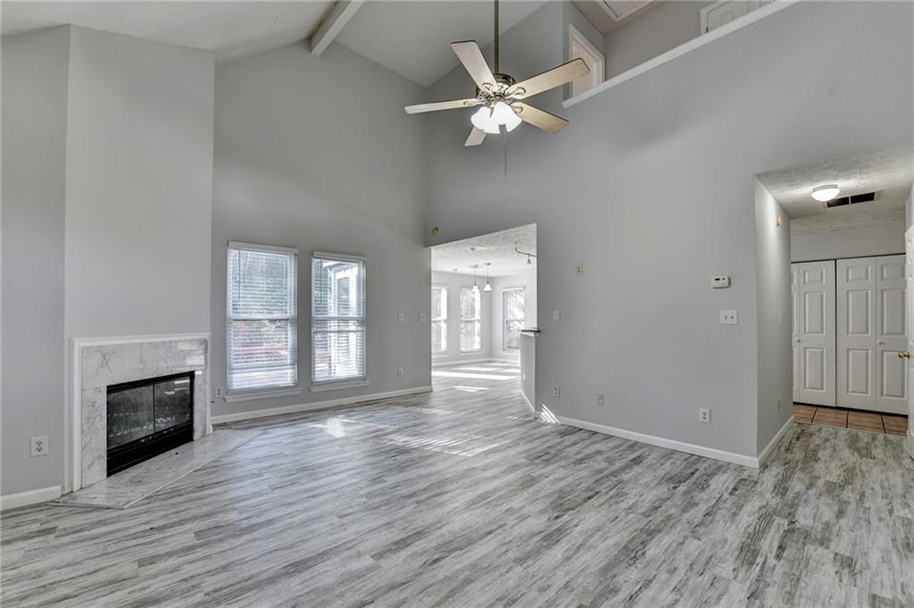 1112 Ashbury Drive Decatur, GA 30030 - Photo 8 of 64 an empty room with wooden floor fireplace and windows