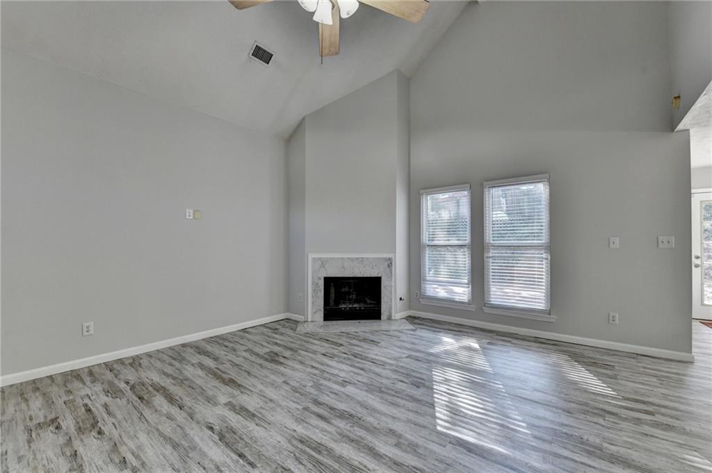 1112 Ashbury Drive Decatur, GA 30030 - Photo 10 of 64 wooden floor fireplace and windows in an empty room