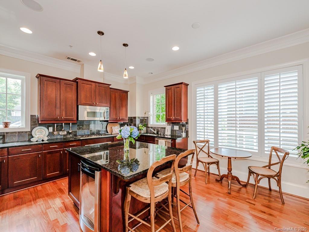 2223 Croydon Road, Unit 204 Charlotte, NC 28207 - Photo 11 of 27 a kitchen with stainless steel appliances granite countertop sink stove and dining table