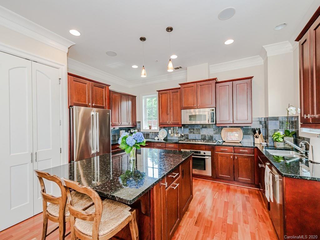 2223 Croydon Road, Unit 204 Charlotte, NC 28207 - Photo 13 of 27 a kitchen with stainless steel appliances granite countertop counter space cabinets and a center island
