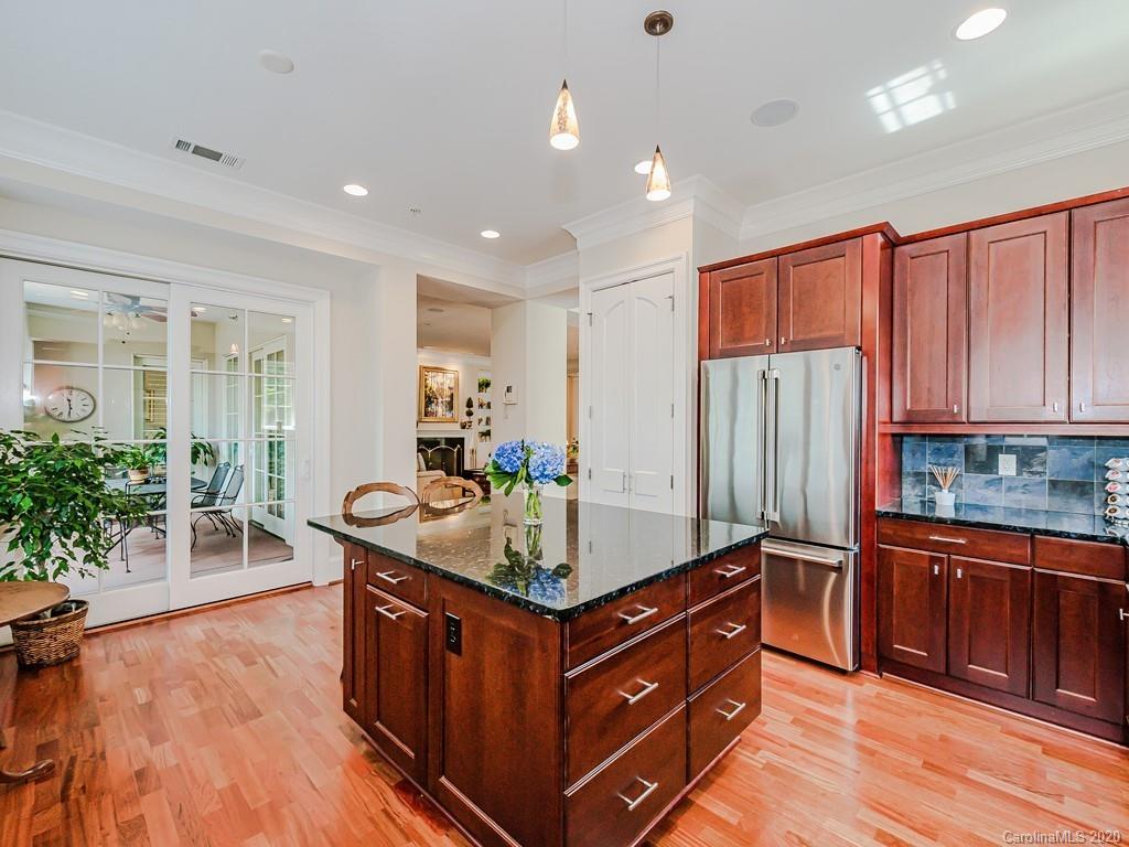 2223 Croydon Road, Unit 204 Charlotte, NC 28207 - Photo 14 of 27 a kitchen with stainless steel appliances granite countertop a stove a sink and a refrigerator
