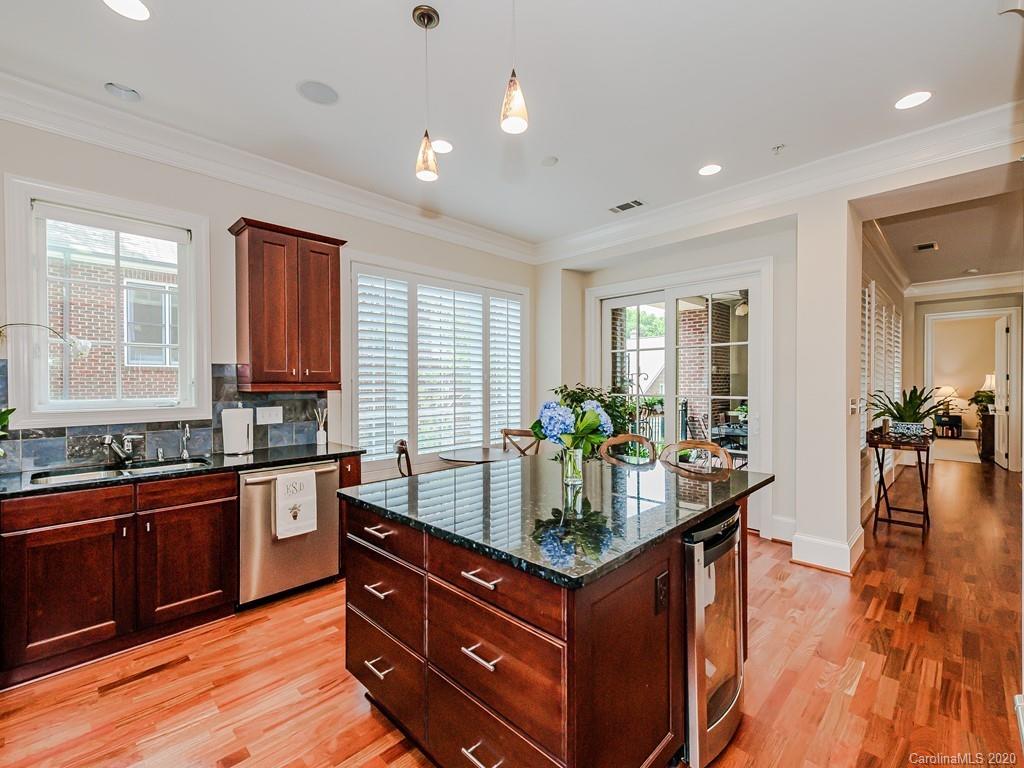 2223 Croydon Road, Unit 204 Charlotte, NC 28207 - Photo 15 of 27 a kitchen with granite countertop lots of counter top space and wooden floor