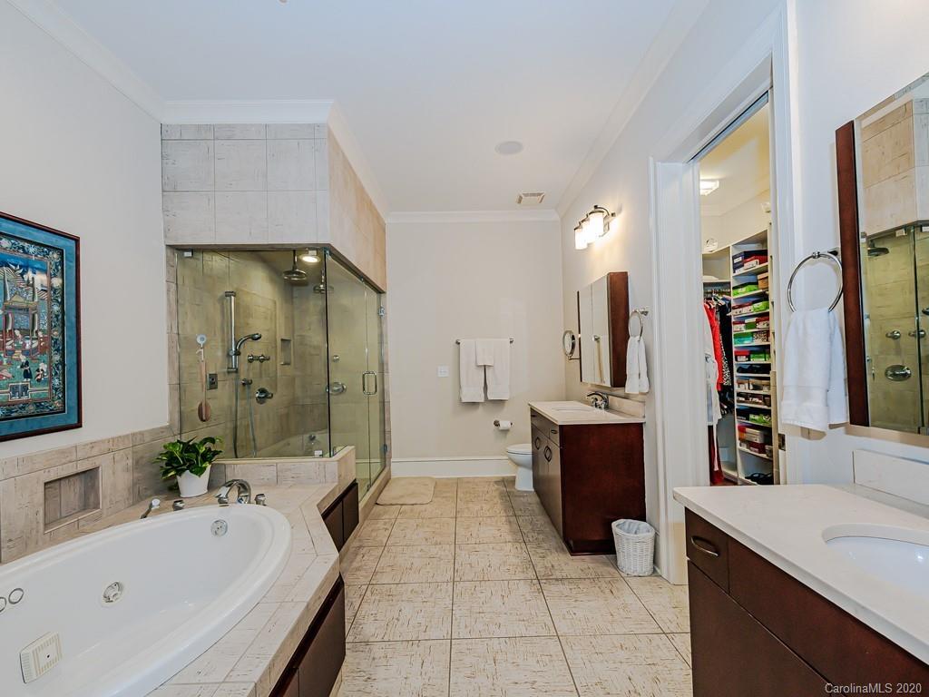 2223 Croydon Road, Unit 204 Charlotte, NC 28207 - Photo 17 of 27 a large bathroom with a tub sink shower and mirror