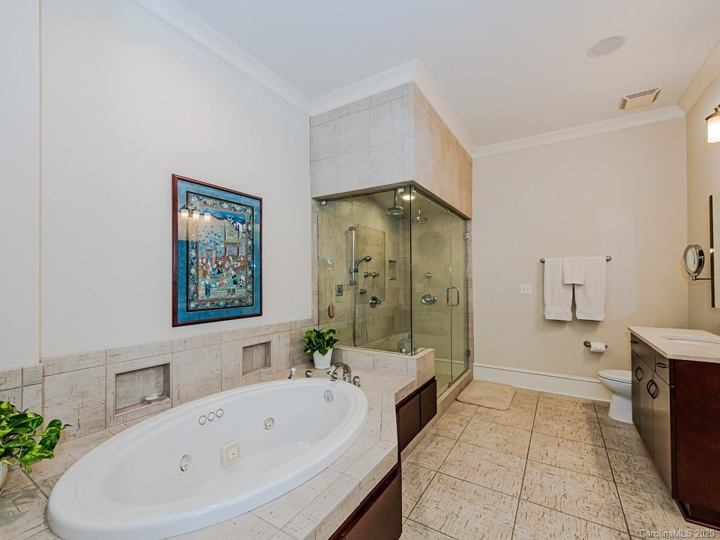 2223 Croydon Road, Unit 204 Charlotte, NC 28207 - Photo 18 of 27 a bathroom with a tub a sink and a shower