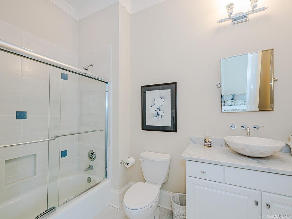 2223 Croydon Road, Unit 204 Charlotte, NC 28207 - Photo 23 of 27 a bathroom with a sink toilet and shower