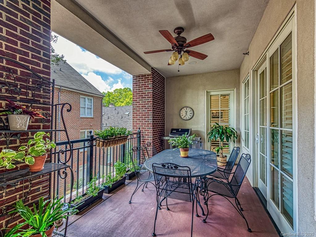 2223 Croydon Road, Unit 204 Charlotte, NC 28207 - Photo 24 of 27 a view of a porch with furniture and a yard