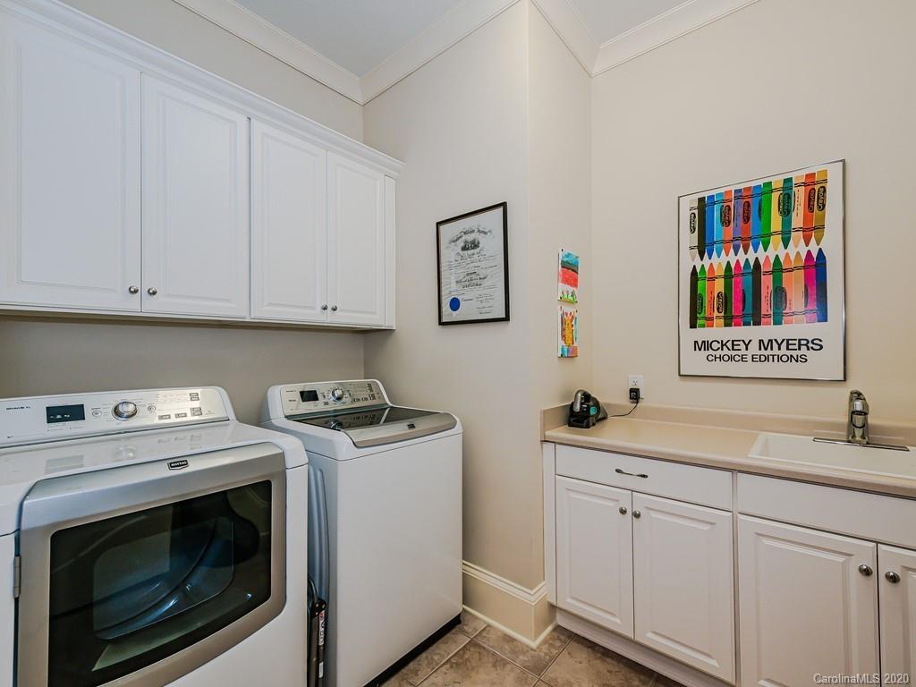 2223 Croydon Road, Unit 204 Charlotte, NC 28207 - Photo 26 of 27 a utility room with sink dryer and washer