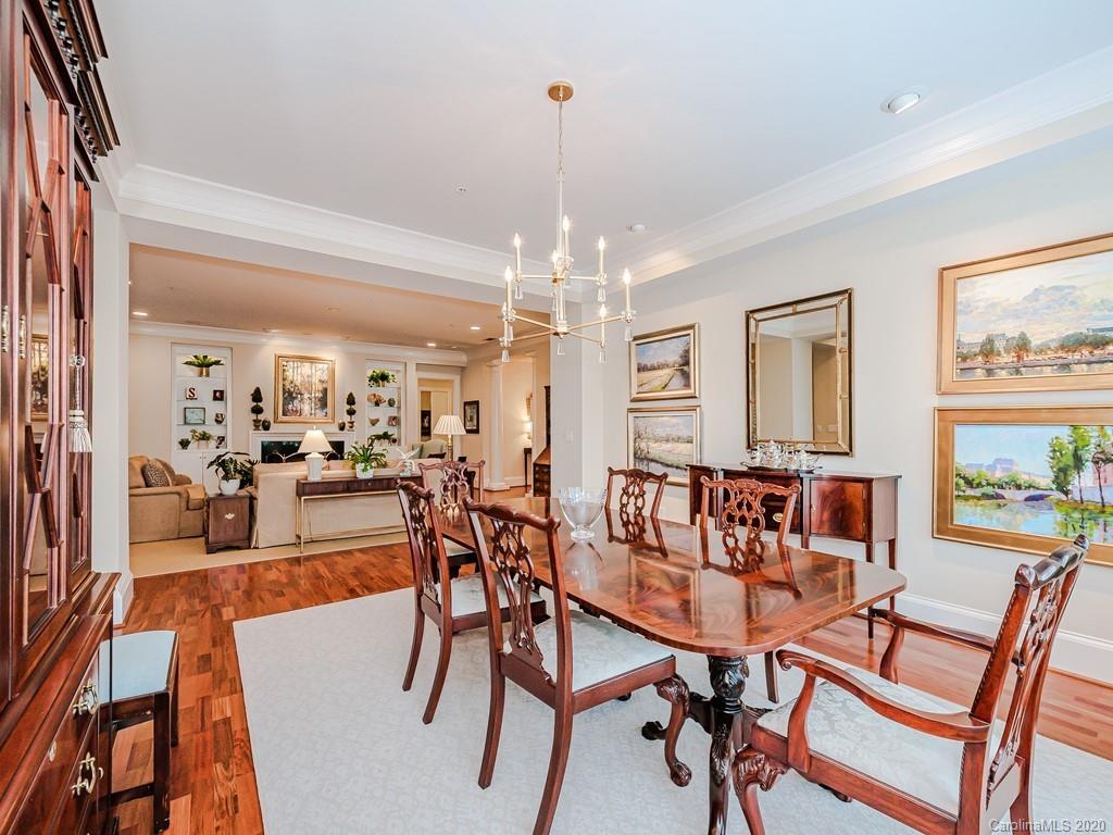 2223 Croydon Road, Unit 204 Charlotte, NC 28207 - Photo 8 of 27 a dining room with furniture a chandelier and wooden floor