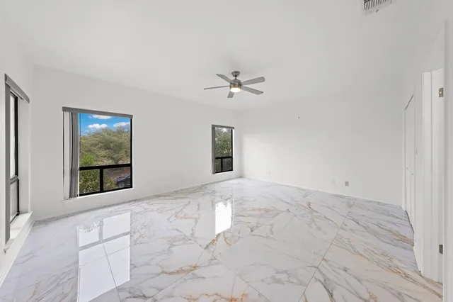 a spacious bathroom with a granite countertop sink a mirror and a shower