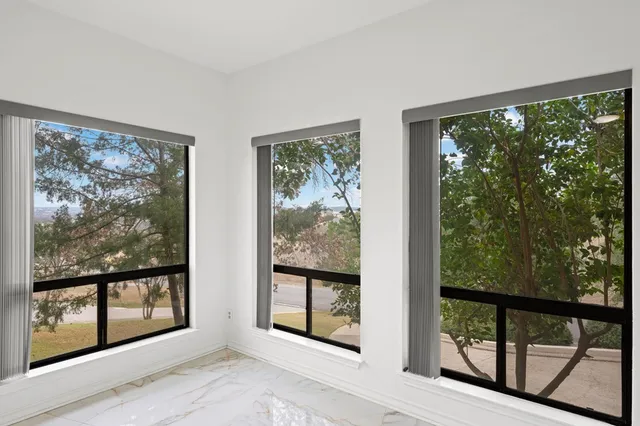 a spacious bathroom with a granite countertop sink a toilet and mirror