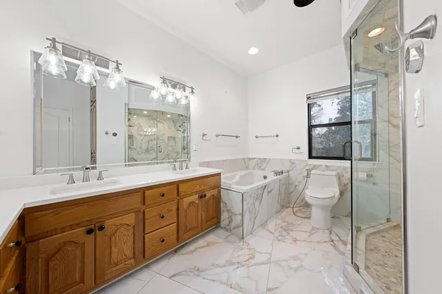 a bathroom with a toilet sink and shower