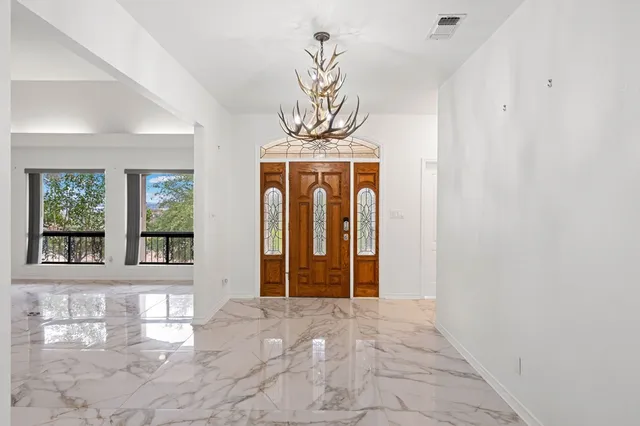 a view of an empty room with a fireplace and a window