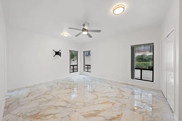 a kitchen with granite countertop a sink and white cabinets