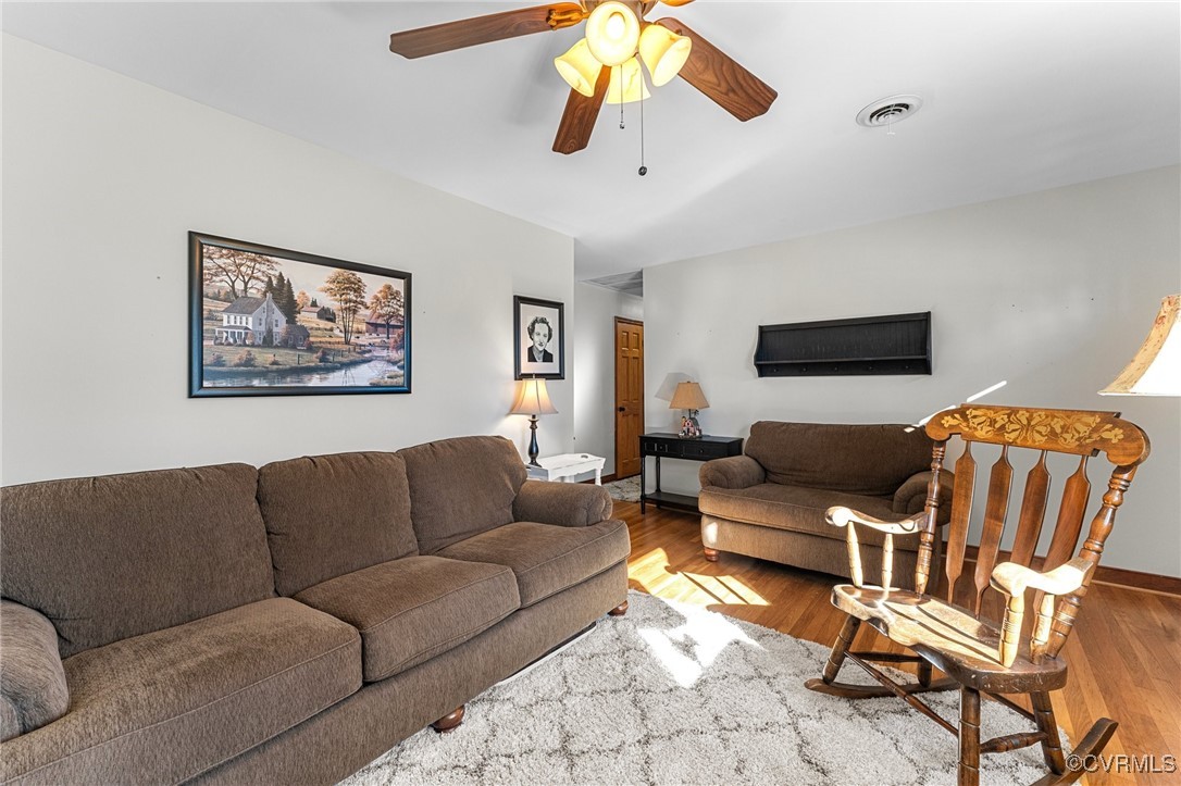 5428 West Hundred Road Chester, VA 23831 - Photo 20 of 48 a living room with furniture a flat screen tv and a chandelier