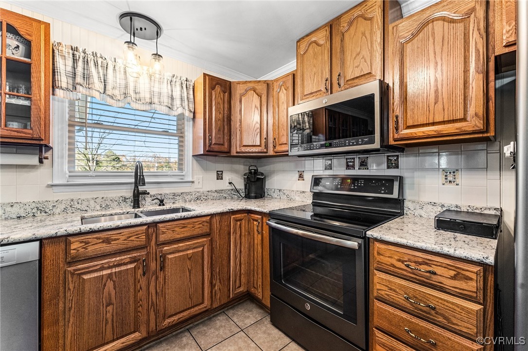 5428 West Hundred Road Chester, VA 23831 - Photo 36 of 48 a kitchen with stainless steel appliances granite countertop wooden cabinets a stove top oven a sink and dishwasher