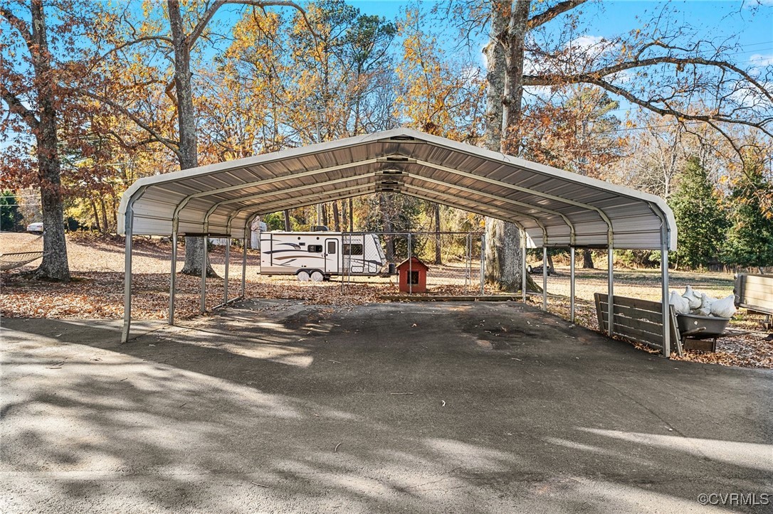 5428 West Hundred Road Chester, VA 23831 - Photo 7 of 48 a backyard of a house with table and chairs under an umbrella
