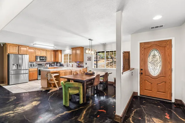a kitchen with furniture a window and appliances