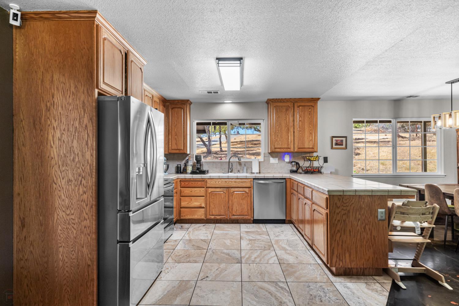 2384 Choctaw Road Copperopolis, CA 95228 - Photo 18 of 53 a kitchen with stainless steel appliances granite countertop a refrigerator a sink dishwasher a stove with wooden cabinets and floor