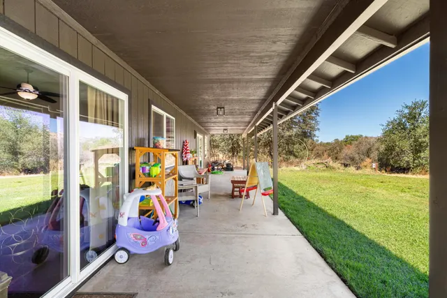 a view of a field with trees in the background