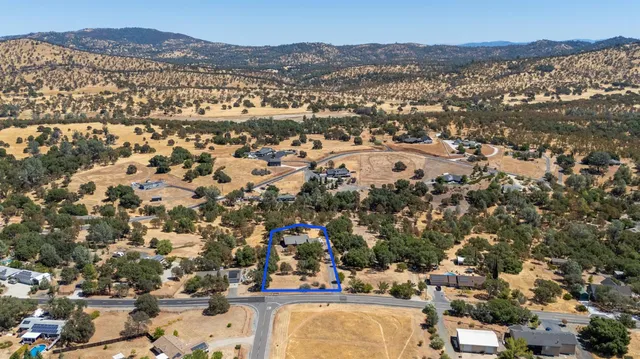 an aerial view of residential houses with outdoor space and mountain view